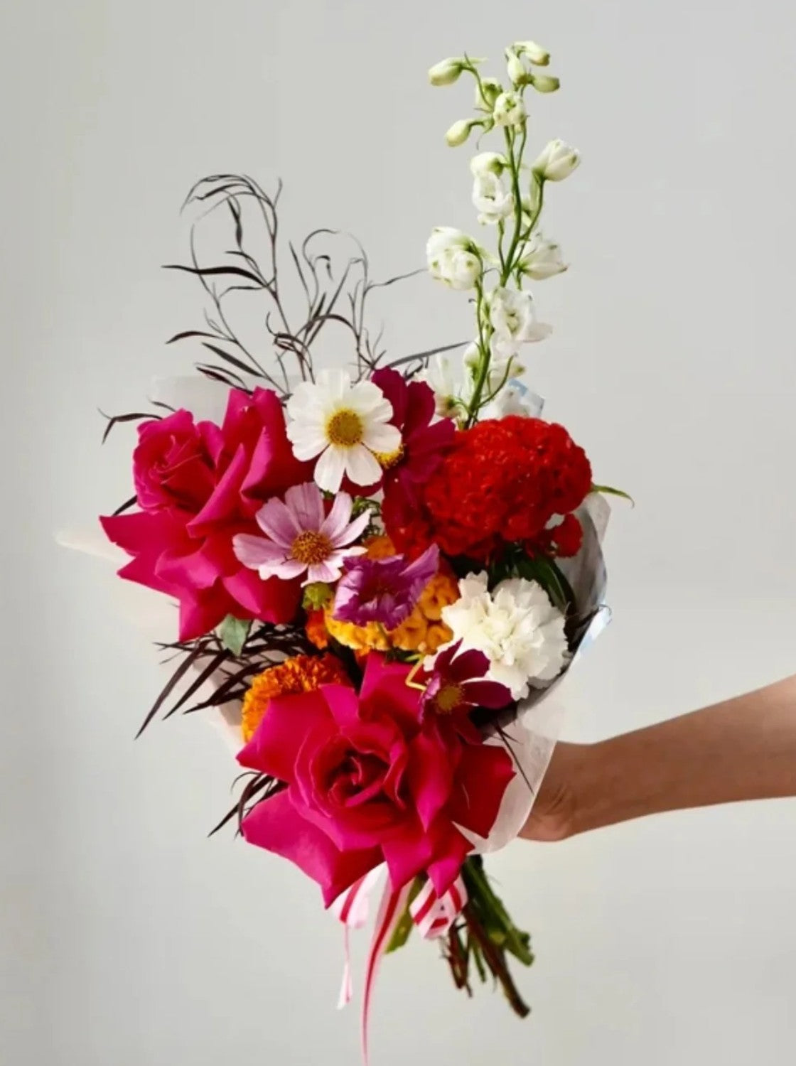 Hand-tied club bouquet with roses, cosmos and delphinium
